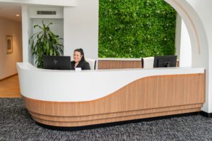 A lady sitting in the reception area of dentist on the Gold Coast clinic