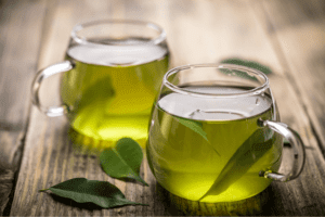 Two cups filled with green tea to kill mouth bacteria.