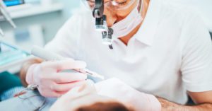 Dentist cleans tooth canals of patient and removes nerve - pulpitis treatment